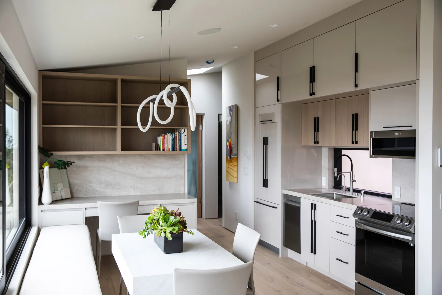 Kitchen and breakfast nook with a sculptural pendant light